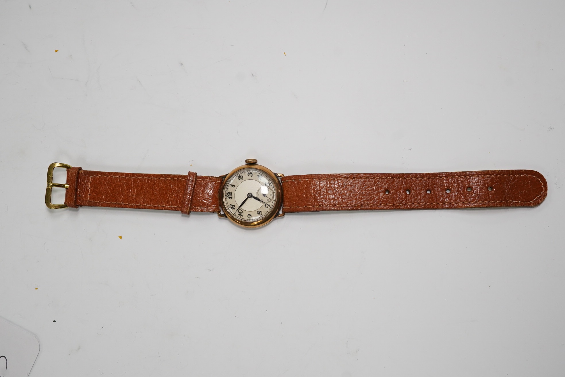 A gentleman's 1930's 9ct gold manual wind wrist watch, with Arabic dial and subsidiary seconds, case diameter 29mm, on a later leather strap. Condition - poor